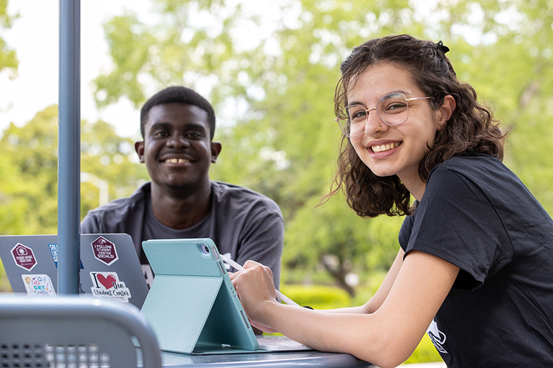 SIU students pose outside Morris Library